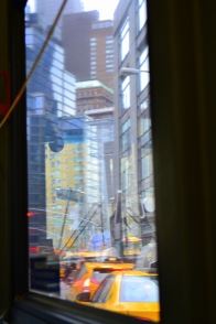 Super surreal reflections mix and mingle with the view outside the window of a city bus.